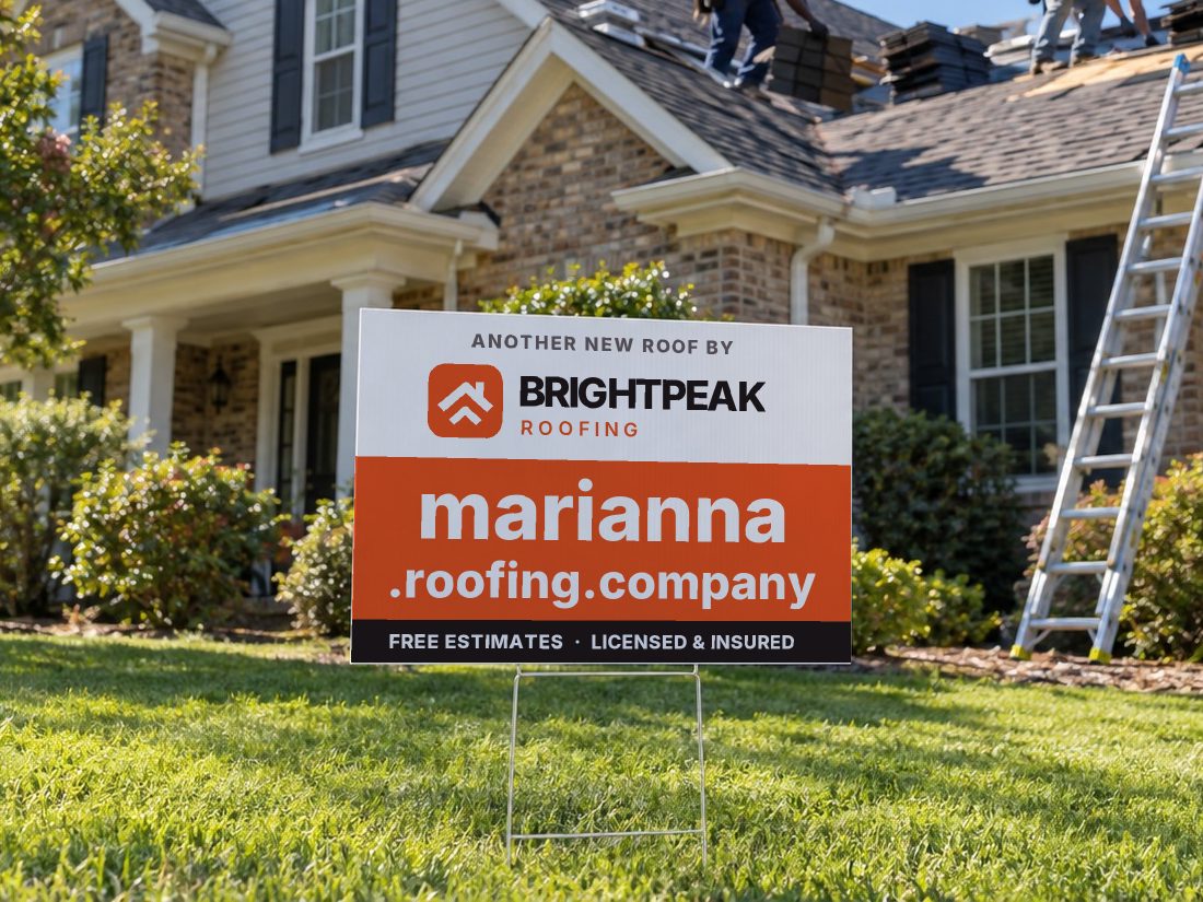 marianna.roofing.company on a yard sign in front of a house getting a new roof